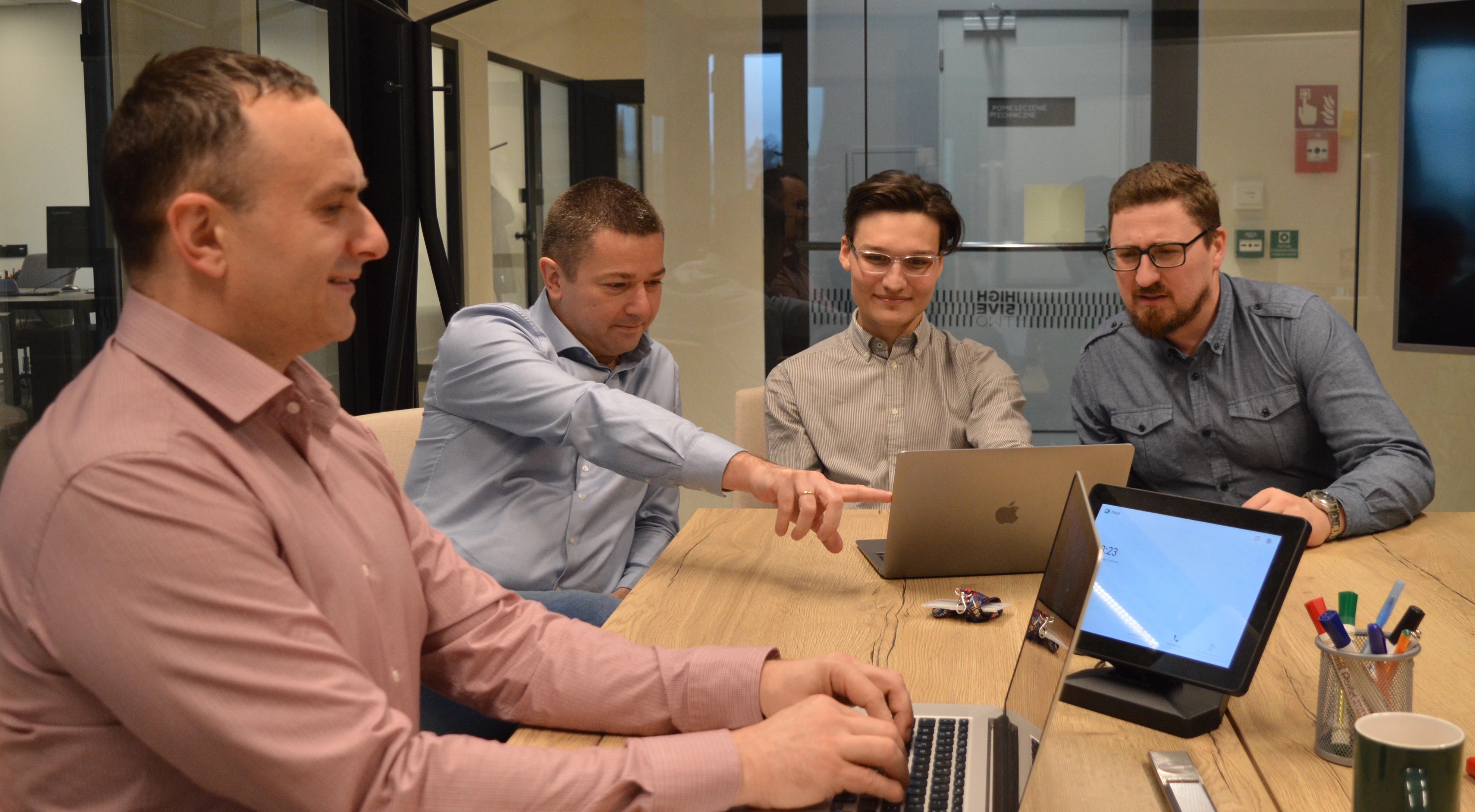 Picture the four co-founders of Accens sitting in front of their laptops in a conference room.